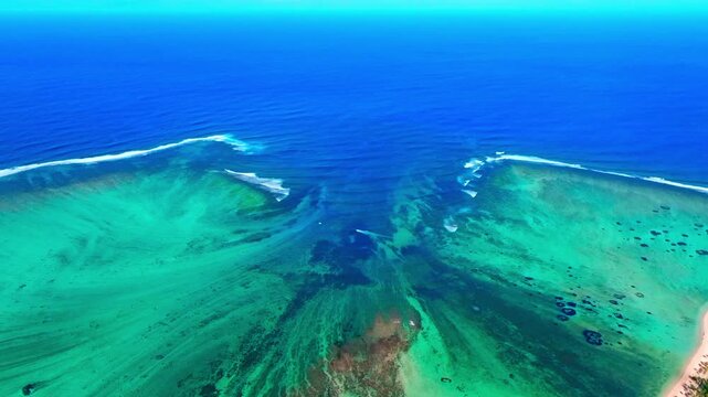 Aerial view of Mauritius island and Le Morne Brabant mountain with beautiful blue lagoon and underwater waterfall illusion background