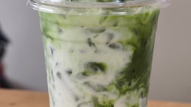 Iced milk matcha in a cup