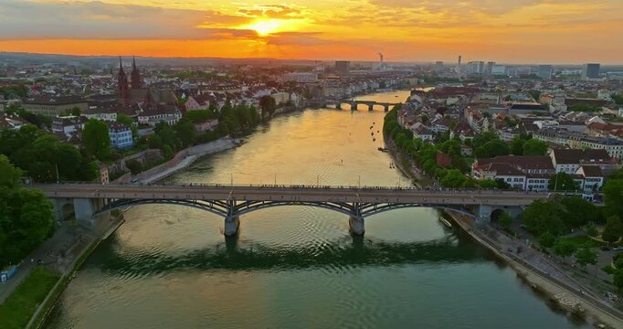 Aerial drone footage of the Basel old town along the Rhine river which contrast with modern skyscrapers in Switzerland. Shot with a forward and rotation motion. 