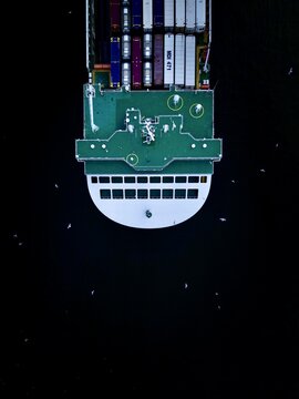 Aerial view of the intricate circuit board and components against a vast, dark expanse, creating a stark contrast of technology and emptiness, Location Omitted, Location Omitted.