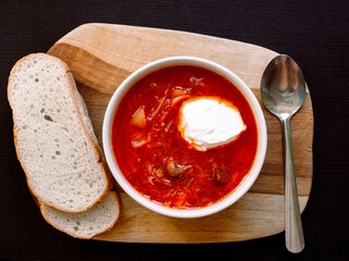 ukrainian borsch with red cream, on a wooden board. top view, free space for your text