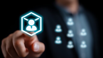 A focused hand interacts with a glowing hexagonal interface displaying a stylized human figure, suggesting selection or access to personal data within a digital system.