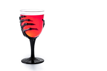 Halloween spooky red cocktail in skeleton hand glass isolated on white background. Copy space
