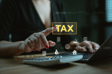 Close-up of a woman using a calculator and laptop, with holographic icons representing finance,...