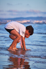Boy enjoys beach time and water play