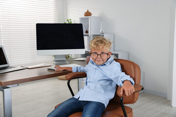 Choice of profession. Little boy pretending to work in office