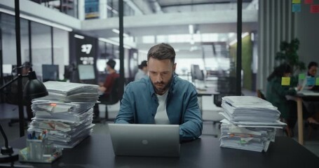 Tired Man Overwhelmed with Work Sitting and Working on a Laptop Computer. Tasks Keep Piling Up and Adding to His Stress Level. Male Managers Closes the Laptop and Leaves - Powered by Adobe