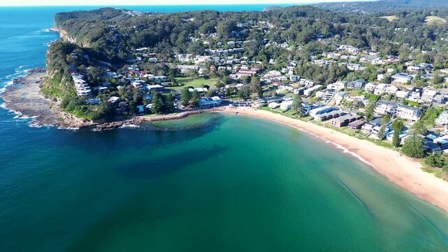 Drone aerial landscape of scenic Avoca Beach town suburbs on headland coastline with residential rural housing and sandy ocean bay Central Coast tourism Australia travel nature outdoors surfing