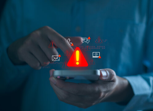 Businessman using computer with system warning alerts, Concept of cyber threat, phishing, scam messages, suspicious calls, and online security risks on communication.
