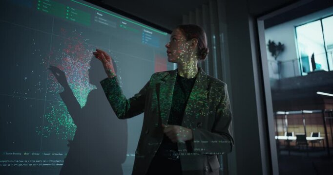 Female IT Professional Delivering a Keynote Presentation on Artificial Intelligence in a Modern Conference Room. She Stands in Front of a Screen with Machine Learning Charts and Digital Data Visuals