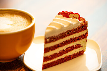 Homemade cake Red Velvet decorated with cream and cup of coffee