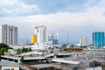 Cluster of modern and mid-rise buildings stand tall against cloudy skies, showcasing the dynamic growth of the cityscape and its evolving mix of urban development and architecture.