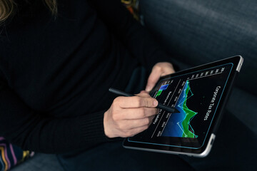 Digital Financial Analysis: A Person Using a Stylus to Examine Corporate Tax Trends on a Tablet