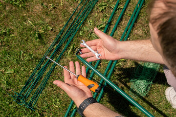 Assembling a garden garter for plants. Support and garter for plants. Accessories and tools for...