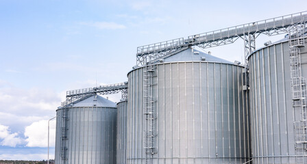 Modern steel agricultural grain granary silos. Agricultural silos for storage of grain harvest at an agricultural production farm.