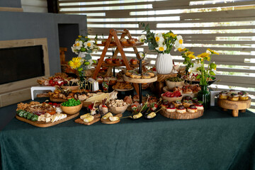 Catering buffet with variety of food snacks and appetizers.