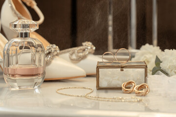 Wedding accessories rings, shoes and perfume on a table