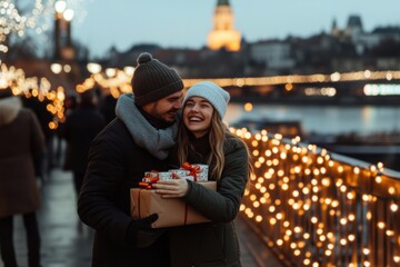 Happy couple exchanging Christmas gifts in city lights
