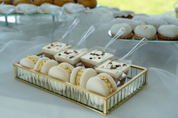 Candy bar with  with macaroons, different sweets and cupcakes. Wedding buffet.