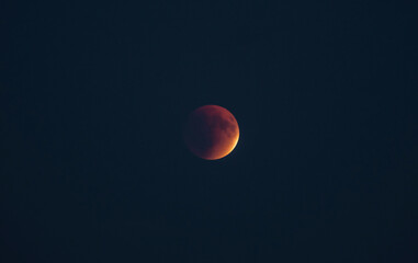 The part is only covered by shadow. The lunar eclipse or blood moon photo in the night sky