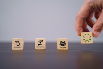 CRM, Customer relationship management concept. Customer satisfaction, retention strategies. CRM or customer loyalty program banner. Wooden cube blocks with CRM symbols on minimal background.