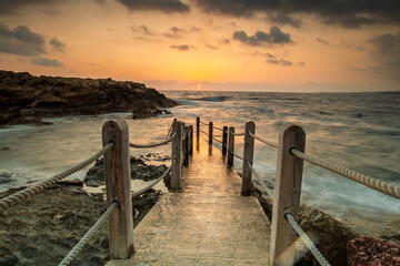 Obraz premium Cyprus Mediterranean Coastline with Turquoise Sea, Sandy Beach, and Clear Blue Sky