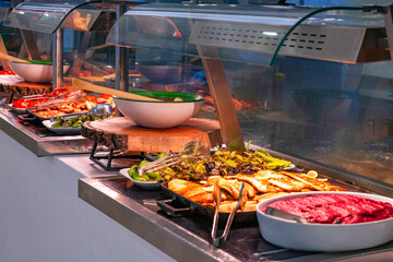Close-up of a luxury hotel meat open buffet. Roast and grilled lamb, goat, beef and chicken, served...