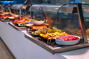 Close-up of a luxury hotel meat open buffet. Roast and grilled lamb, goat, beef and chicken, served...