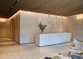 Modern reception area with light wood paneling and terrazzo floor lobby interior