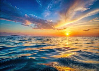 Obraz premium Serene ocean at sunset with gentle waves and soft ripples on the surface