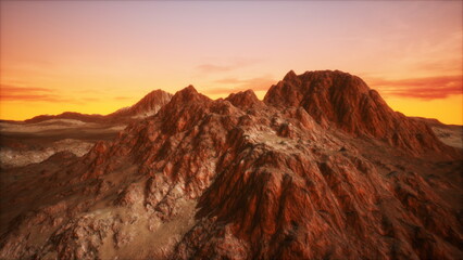 Vivid orange and purple hues light up the rugged mountain peaks as the sun sets behind the horizon. The rocky terrain glistens, creating a stunning view in the evening atmosphere.