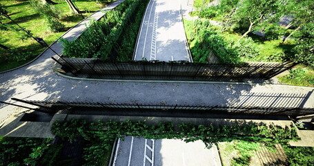 The park entrance features a modern design with lush greenery on both sides. Winding pathways invite visitors to explore the tranquil environment. Bright sunlight enhances the peaceful atmosphere.