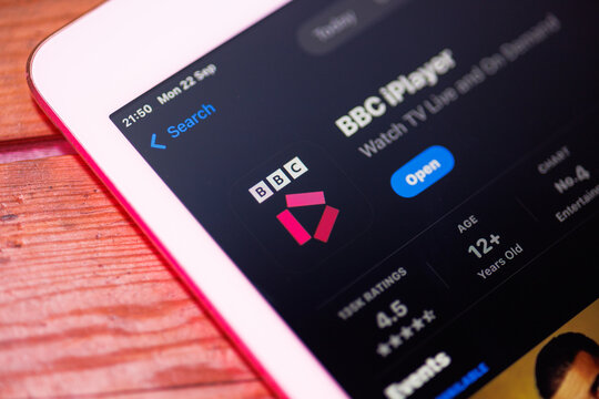 iPad on wooden table displaying the BBC iPlayer app on the App Store, modern technology and digital lifestyle concept