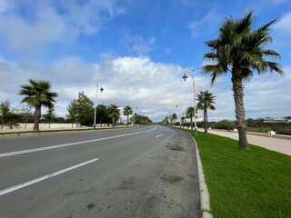 the street near the green grass in blue sky in the city of Martil, Tetouan. morocco