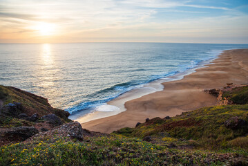 Golden Sunset Over Atlantic Waves on the Sandy Beach of Nazare, Portugal Coastline
