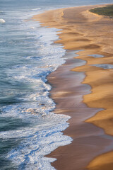 Golden Sandy Beach with Rolling Atlantic Ocean Waves in Nazare, Portugal, Famous Surf Destination