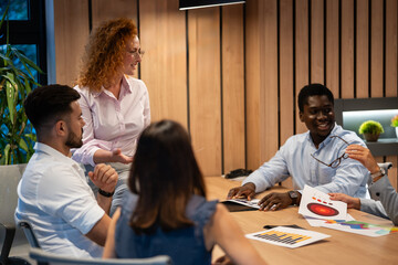 Team of diverse colleagues collaborating in creative business meeting