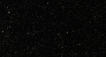 Fototapeta premium Close-up view of a dark, speckled surface, possibly granite or a similar material.