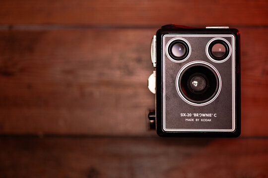 Close-up of a vintage Kodak Six-20 Brownie C box camera on a wooden surface