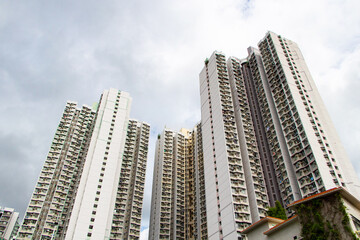 Landscapes large building structure in business district in big city. Architecture of construction. Building top with sky with white clouds and bright sunlight shining through is background.