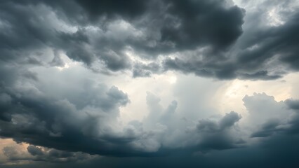 Obraz premium Dramatic storm clouds forming texture across the sky, with natural light and a balanced minimal composition providing large copy space