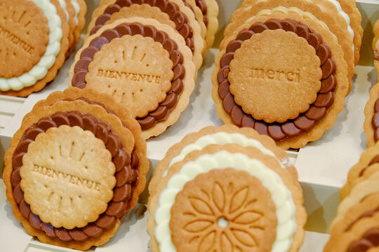 Paris, France.  Europe.  Fresh baked cookies with French words stamped on them. Merci (thank you) and Bienvenue (welcome)