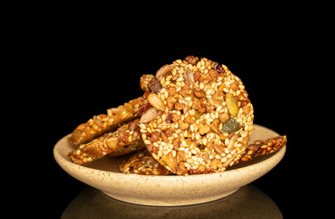 Thaler cookies with nuts and honey isolated on black background, close-up.