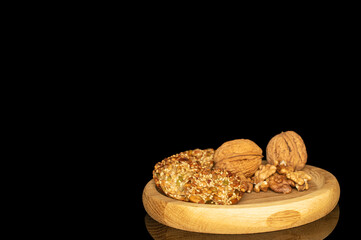 Thaler cookies with nuts and honey isolated on black background, close-up.