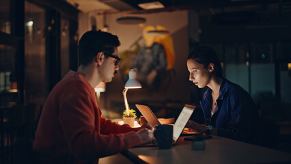 Late workers frustrated failure closing laptop at dark workplace closeup. 