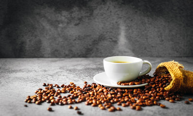 Coffee cup and coffee beans in sack on gray background, Espresso crema coffee cup aromatic
