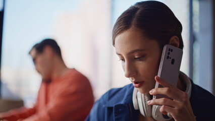 Telemarketing team talking smartphones at workplace closeup. Serious woman man