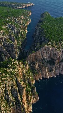  Aerial View of Calanque dEn-Vau near cassis town provence France. Breathtaking view of bay, a beautiful blue lagoon with a white sand beach, surrounded by cliffs, pines, near Marseille in France