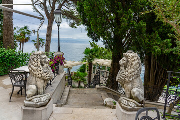 Marble lion statues on elegant seaside terrace with stairs in Opatija, Croatia