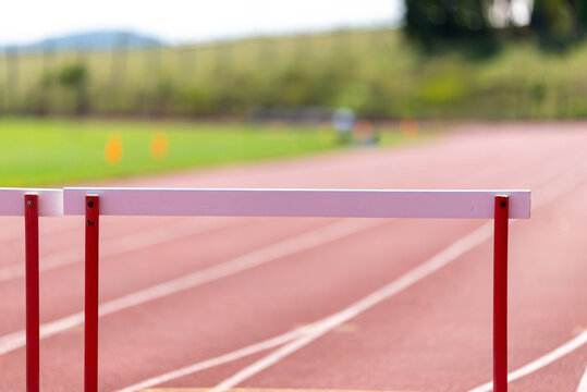 Full hurdle on athletics running track - Powered by Adobe